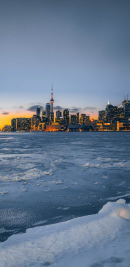[2436x1125]冬季 结冰 城市 高楼 晚霞 苹果手机壁纸图片