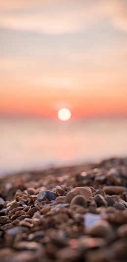 [2436x1125]夕阳 落日 石头 石滩 苹果手机壁纸图片