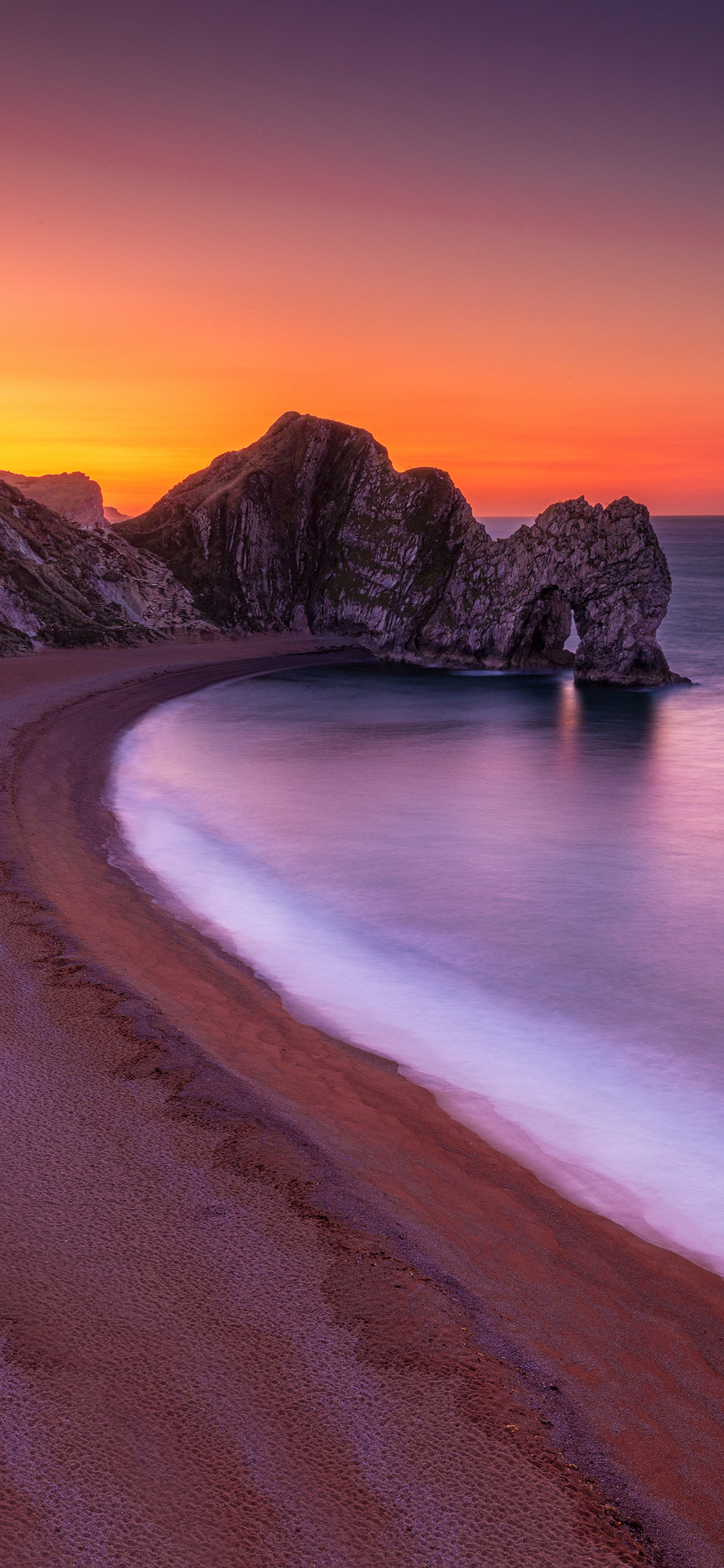 [2436×1125]大海 岩石 晚霞 海滩 美景 苹果手机壁纸图片