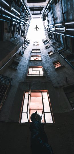 [2436x1125]飞机 建筑 仰望 飞行 天空 楼房 苹果手机壁纸图片
