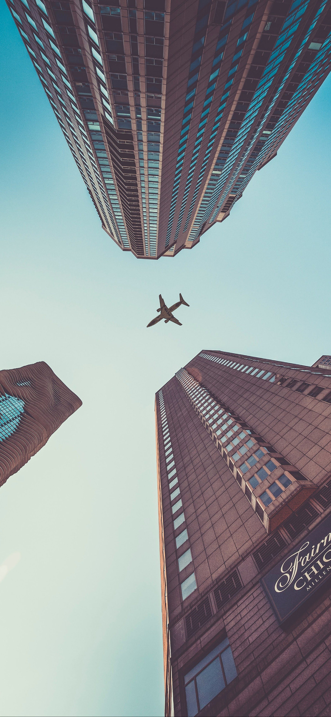 [2436×1125]飞机 建筑 城市 飞行 航空 客机 苹果手机壁纸图片